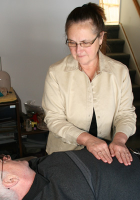 Photo of helen Sladden working with a reiki client